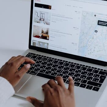 pexels-photo-5077049-5077049 Hands typing on laptop searching Airbnb for accommodation options with map view.